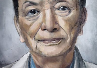 An oil painting of actor James Hong, on board. Centrally lit, James wears a light tan jacket with sky-blue dress shirt.